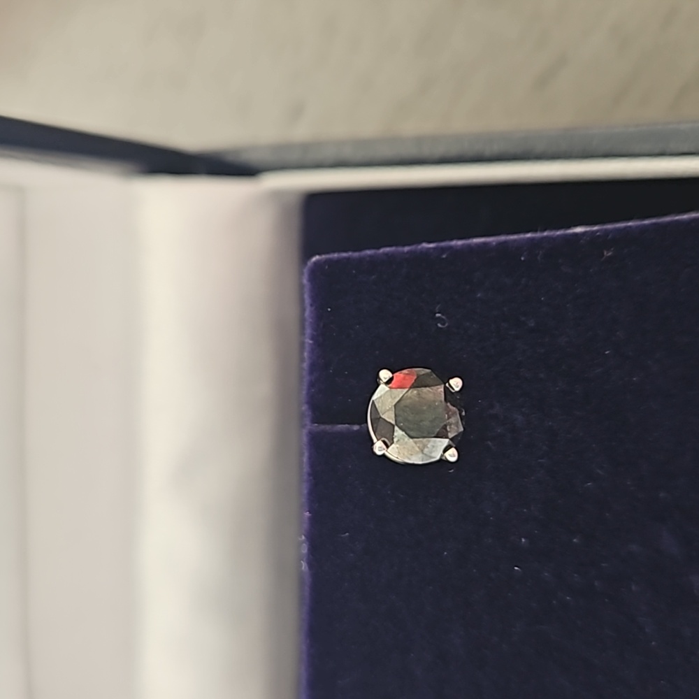 Single black diamond earrings set in white gold.